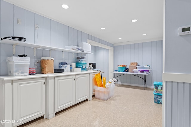 kitchen with white cabinets and wooden walls