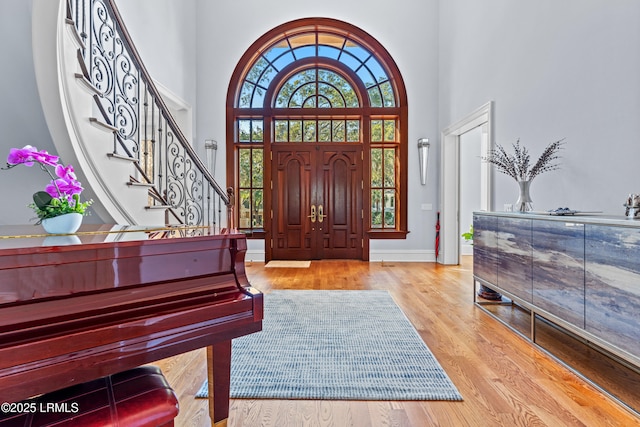 foyer featuring light hardwood / wood-style flooring and a high ceiling