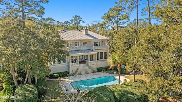 back of house featuring a patio and a balcony