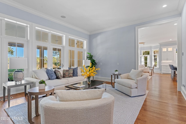 living room with crown molding and light hardwood / wood-style floors