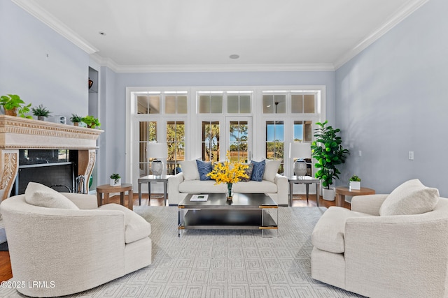 living room with crown molding, a fireplace, and light hardwood / wood-style flooring