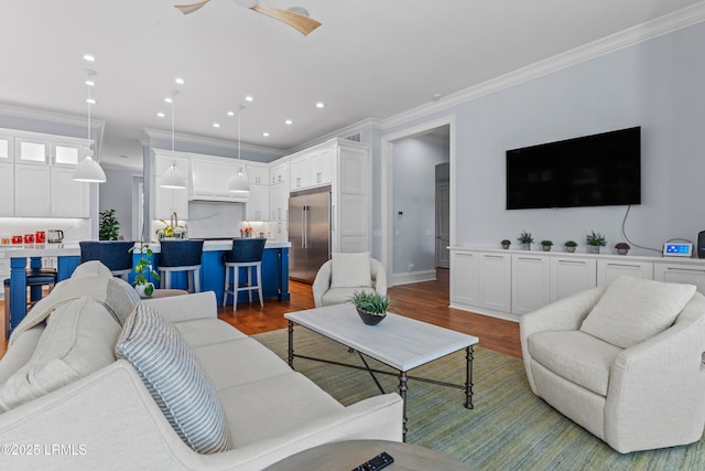 living room with crown molding, dark wood-type flooring, and ceiling fan