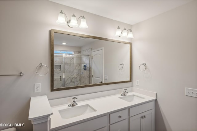 bathroom with vanity and a shower with shower door