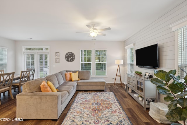 living room with ceiling fan and dark hardwood / wood-style flooring