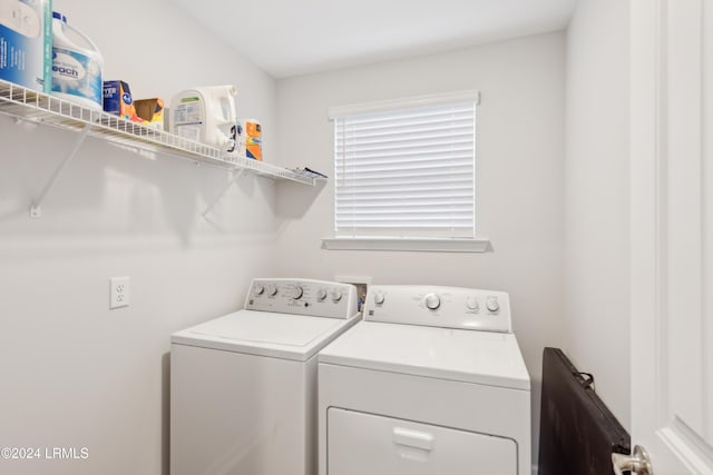 clothes washing area featuring washer and clothes dryer