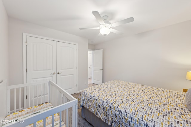 carpeted bedroom featuring ceiling fan and a closet