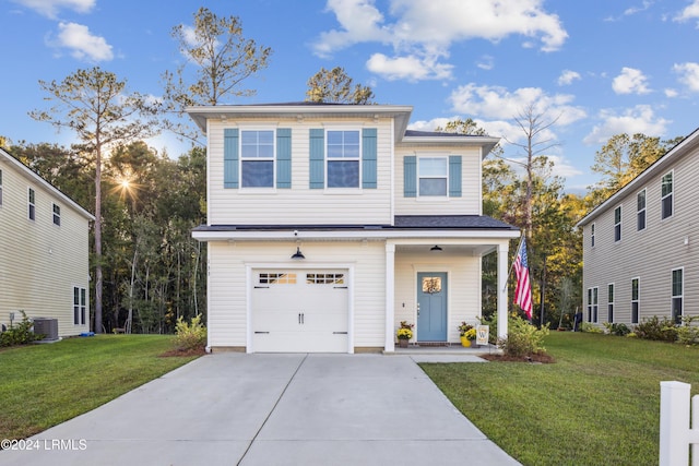 view of front of home with a garage, central AC, and a front lawn