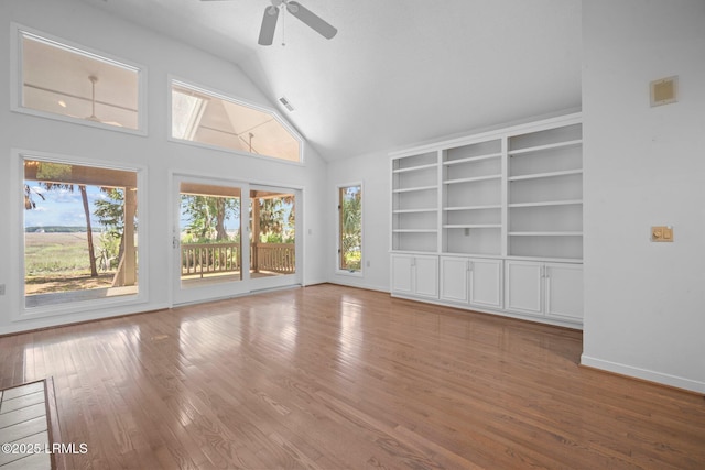 647 Island Cir E, Saint Helena Island, SC 29920 - empty room featuring lofted ceiling, wood finished floors, a ceiling fan, baseboards, and built in shelves
