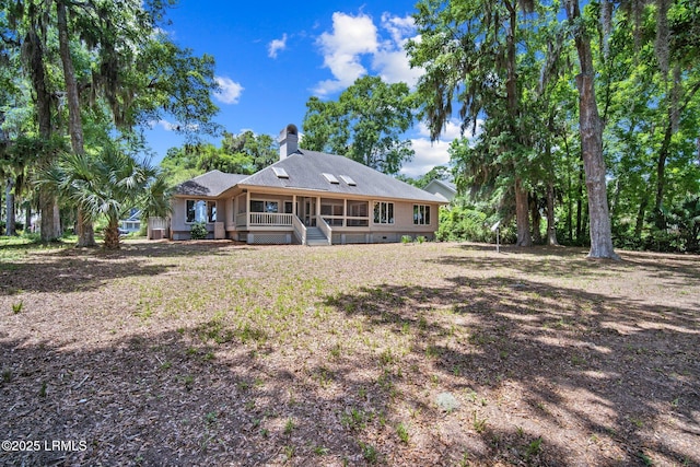 647 Island Cir E, Saint Helena Island, SC 29920 - back of property featuring a chimney and a sunroom