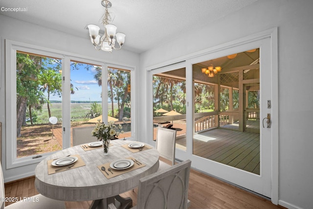 647 Island Cir E, Saint Helena Island, SC 29920 - dining space with a chandelier, wood finished floors, and baseboards