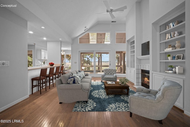 647 Island Cir E, Saint Helena Island, SC 29920 - living area with a tiled fireplace, a ceiling fan, built in shelves, wood-type flooring, and recessed lighting
