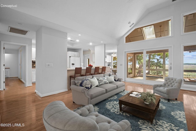 647 Island Cir E, Saint Helena Island, SC 29920 - living area featuring light wood-type flooring, recessed lighting, high vaulted ceiling, a chandelier, and baseboards