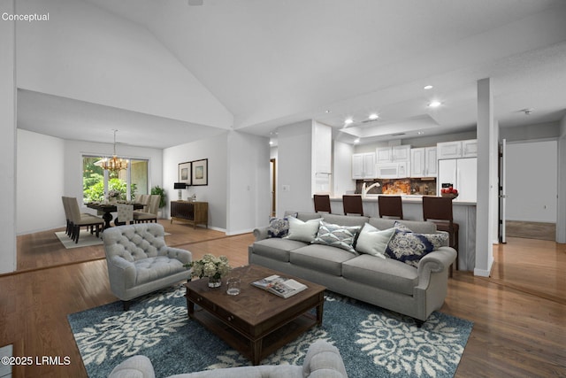 647 Island Cir E, Saint Helena Island, SC 29920 - living room featuring a chandelier, wood finished floors, high vaulted ceiling, recessed lighting, and baseboards