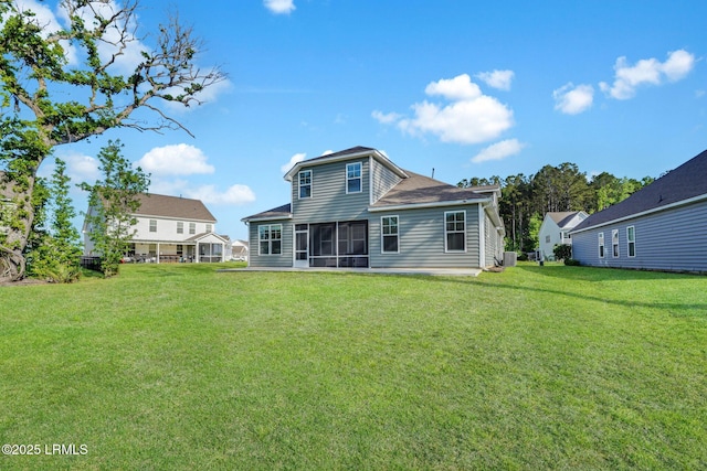 rear view of house with cooling unit, a yard, and a sunroom