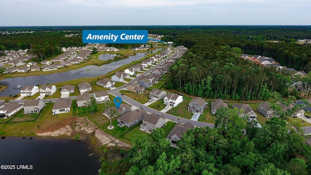 aerial view featuring a residential view, a water view, and a wooded view