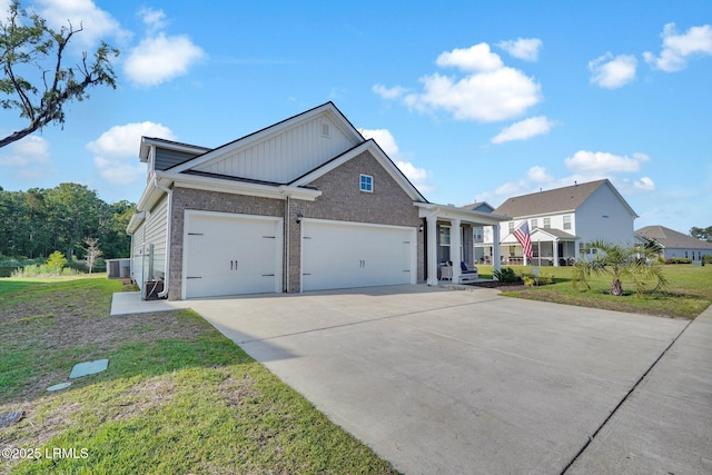 view of front facade featuring brick siding, a front lawn, driveway, and an attached garage