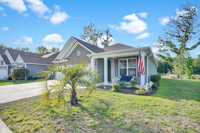 view of front of house with a porch, a front yard, and driveway