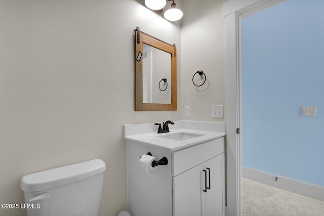 half bathroom featuring toilet and vanity