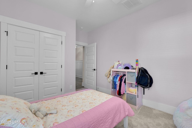 bedroom with a closet, ceiling fan, carpet flooring, baseboards, and visible vents