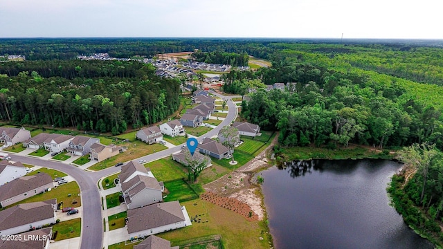 bird's eye view with a water view, a view of trees, and a residential view