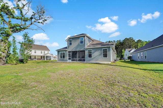 rear view of property with a sunroom, central air condition unit, and a lawn