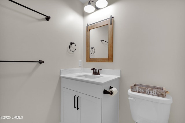 bathroom with toilet and vanity