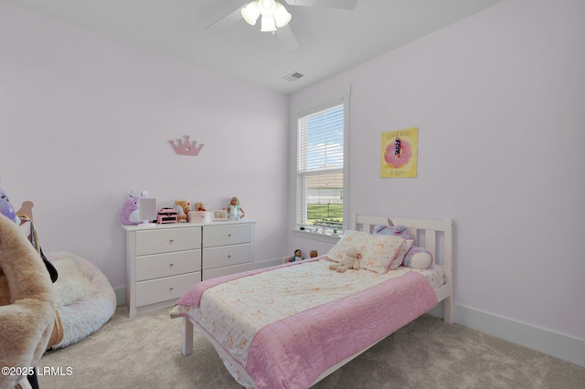 carpeted bedroom with visible vents, a ceiling fan, and baseboards