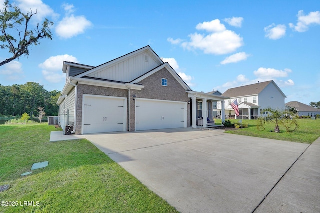 view of front of property with driveway, cooling unit, a front yard, brick siding, and a garage