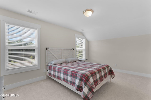 bedroom with baseboards, visible vents, carpet, and vaulted ceiling