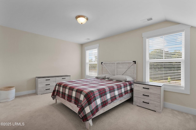 bedroom featuring lofted ceiling, visible vents, light carpet, and baseboards