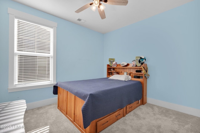 carpeted bedroom with visible vents, ceiling fan, and baseboards