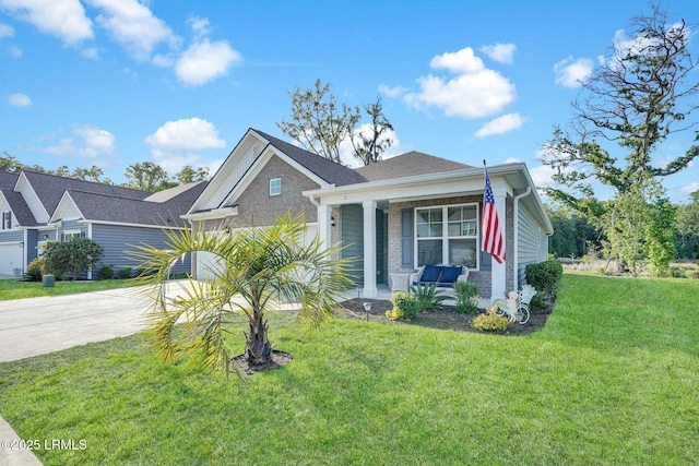 view of front facade featuring covered porch, driveway, and a front yard