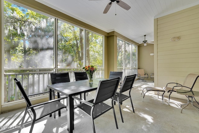 sunroom / solarium featuring ceiling fan