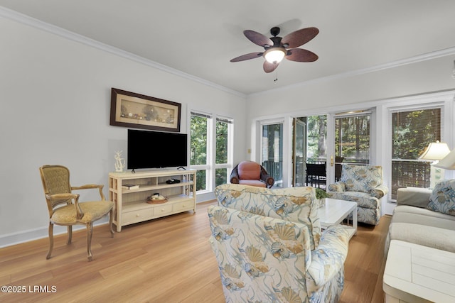 living room with crown molding, ceiling fan, and light wood-type flooring