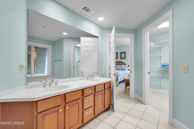 bathroom featuring tile patterned flooring and vanity