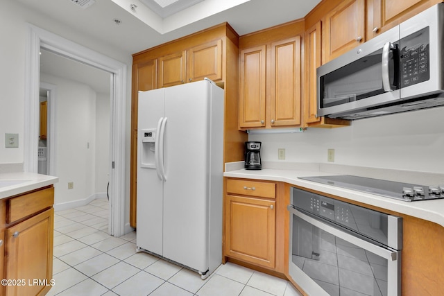 kitchen featuring light tile patterned floors and appliances with stainless steel finishes