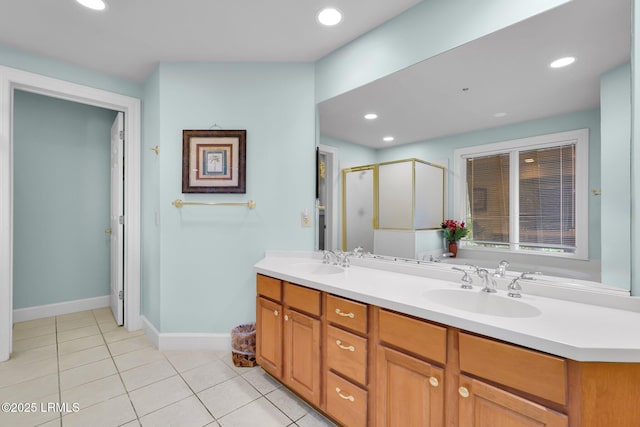 bathroom with walk in shower, vanity, and tile patterned flooring