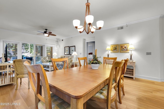 dining room featuring crown molding, light hardwood / wood-style flooring, and ceiling fan with notable chandelier