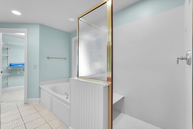 bathroom featuring tile patterned flooring and shower with separate bathtub