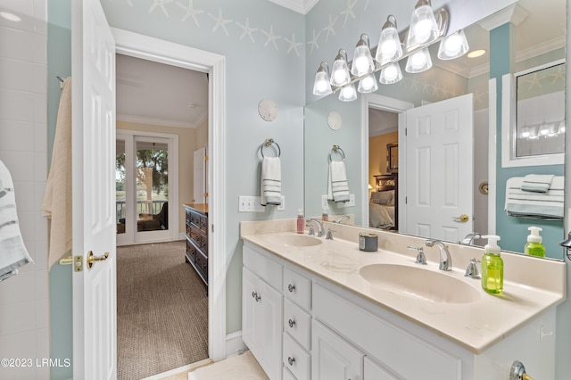 full bathroom featuring ornamental molding, a sink, ensuite bath, and double vanity