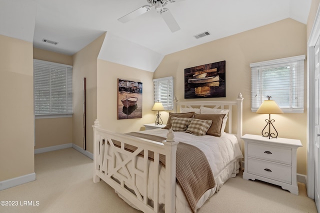 bedroom featuring lofted ceiling, light carpet, visible vents, and baseboards