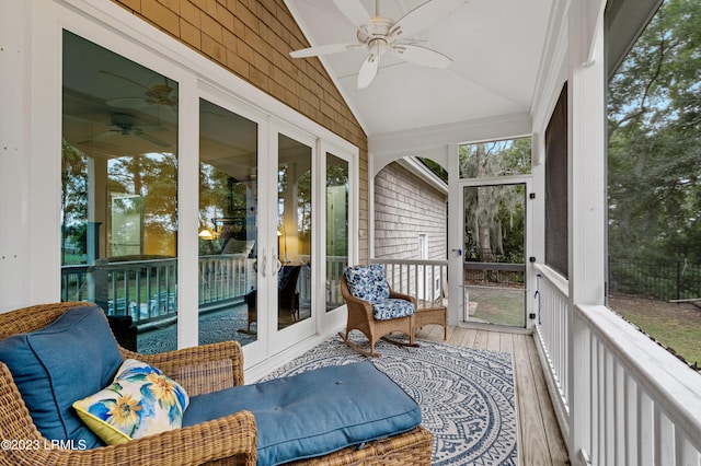 sunroom / solarium with ceiling fan and vaulted ceiling