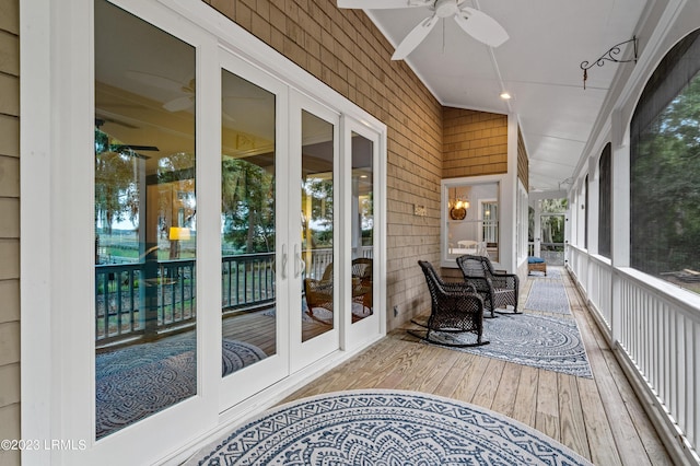 wooden deck featuring a ceiling fan and french doors