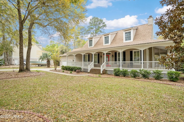 view of front of house with a porch, a front lawn, a chimney, and a shingled roof