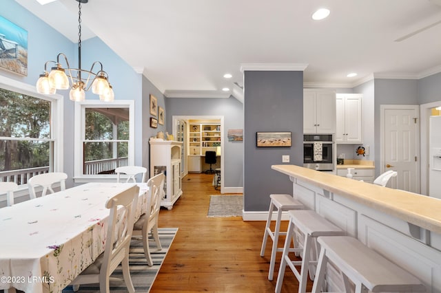 kitchen featuring crown molding, recessed lighting, stainless steel oven, and light wood finished floors