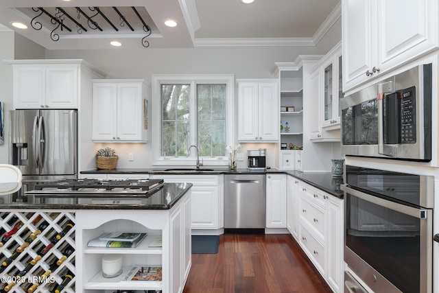 kitchen featuring sink, appliances with stainless steel finishes, dark hardwood / wood-style floors, ornamental molding, and white cabinets