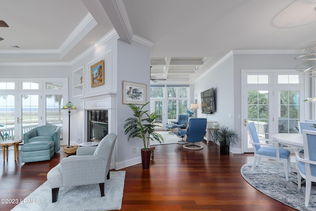 living room featuring beamed ceiling, ornamental molding, a fireplace, and dark hardwood / wood-style flooring