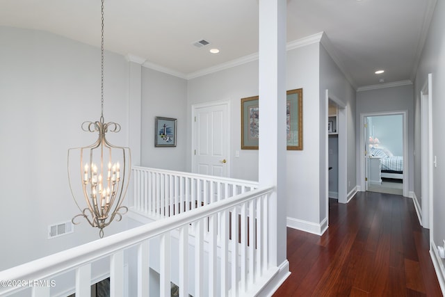 hall featuring ornamental molding, dark wood-type flooring, and a chandelier