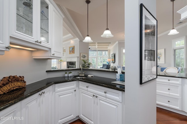 kitchen with pendant lighting, dark stone counters, and white cabinets