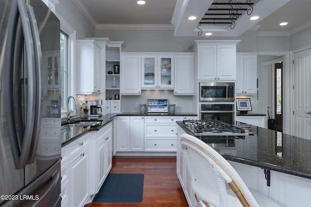 kitchen featuring stainless steel appliances, white cabinetry, sink, and dark hardwood / wood-style flooring